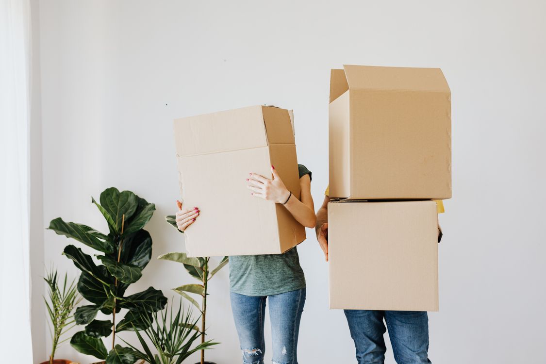 Moving boxes organized with Smatagee QR code labels in a new home